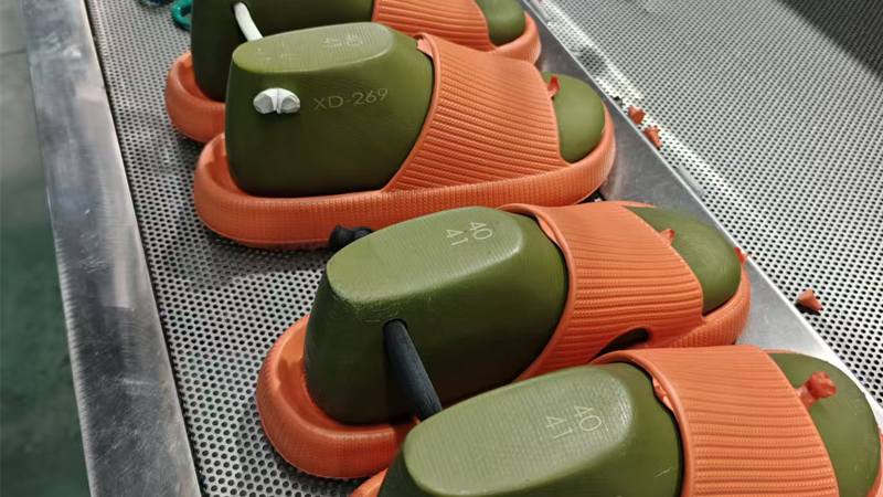 alt="EVA slippers on production line showing deformation and heat sensitivity limitations of EVA material"