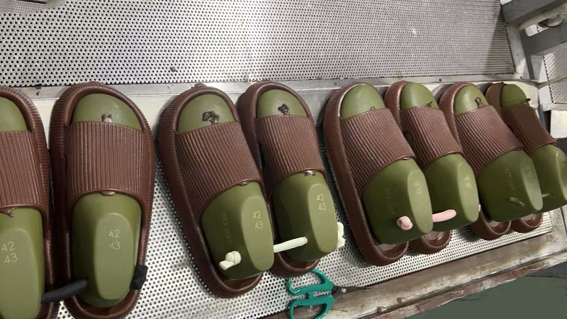 alt="EVA slippers on molds in factory showing OEM production suitability for EVA slipper manufacturing"