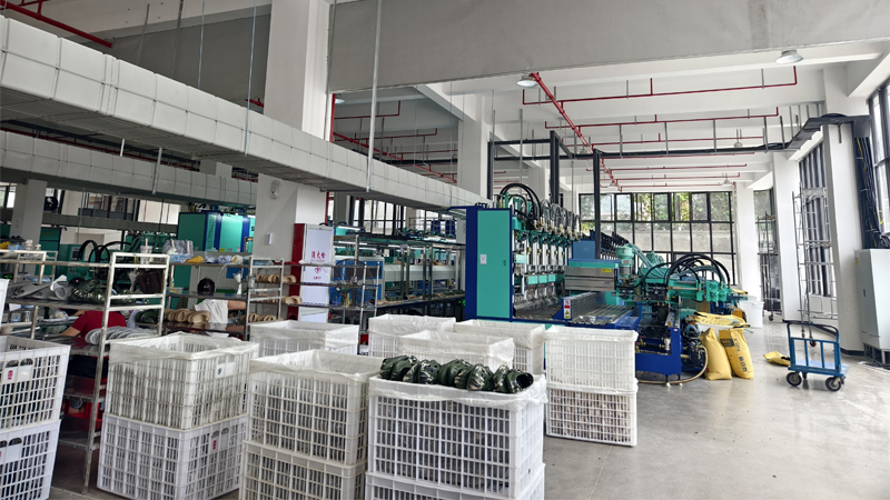 Slipper manufacturing workshop with molding equipment and production lines for EVA and rubber sole footwear