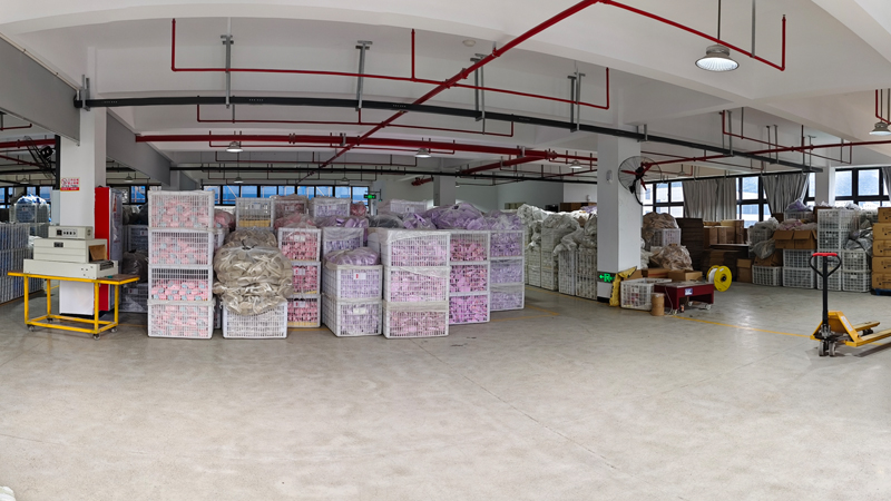 EVA and rubber slipper factory storage area with finished footwear packed for wholesale and OEM orders