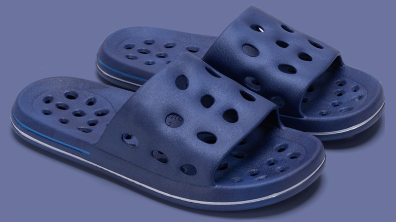 Blue PVC bathroom slippers with drainage holes showing lightweight waterproof design for wet floor use