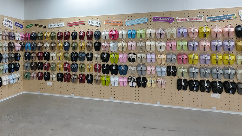 PU and EVA slipper sample display showing multiple colors and styles for OEM footwear manufacturing