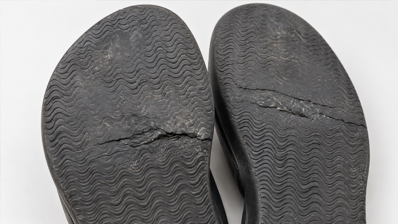 alt="Worn rubber slipper soles showing tread wear and cracking that can reduce durability and slip resistance over time"