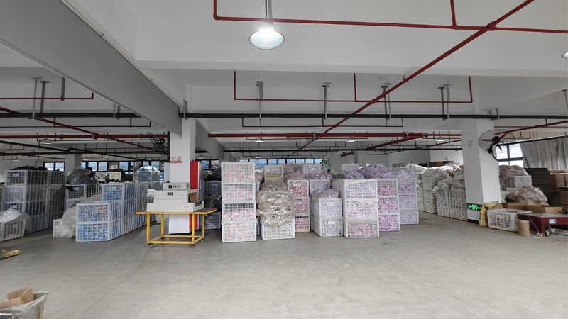 alt="Rubber slipper manufacturing facility with packed finished products stored for OEM production and shipment"